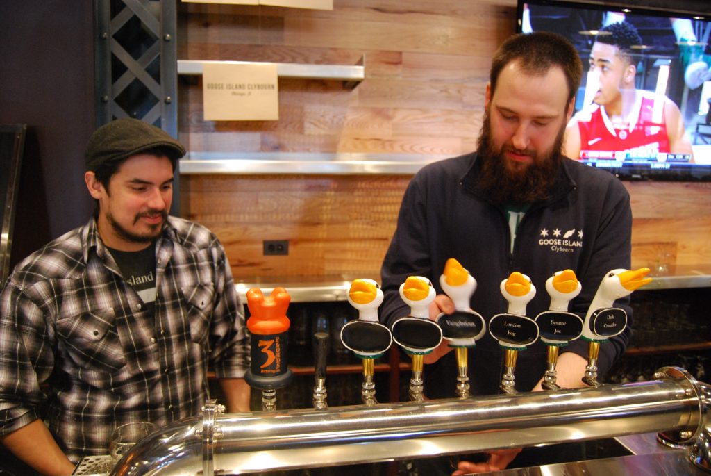 Jacob Sembrano (left) and Jon Naghski (right) pour Goose Island Clybourn's offerings.